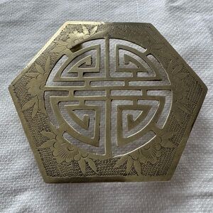 Brass hexagonal trivet with Chinese longevity symbol and floral motifs